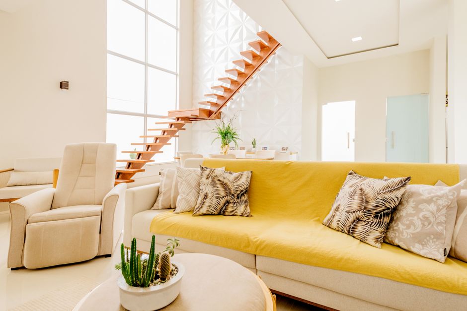 Interior of modern spacious living room with comfortable furniture and white walls and big windows